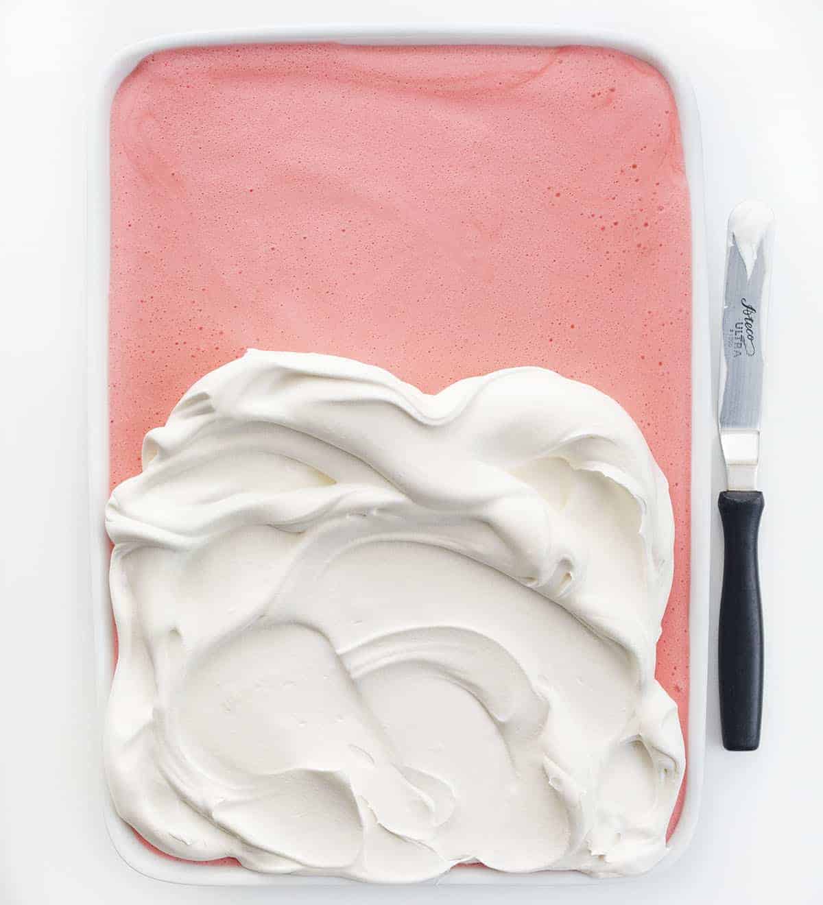 将鲜奶油加到草莓冰箱芝士蛋糕中